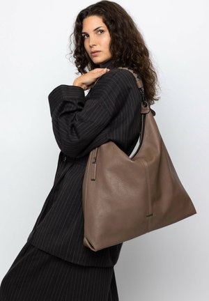 Brown leather shoulder bag with a slouchy shape, featuring a top zip closure and side pocket. Textured surface and adjustable strap.