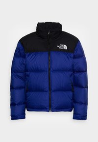 Sininen ja musta vuoritettu talvitakki, jossa on edessä vetoketju ja kaksi sivutaskua, ja rinnassa on The North Face -logo.