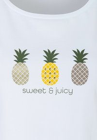 White shirt featuring three pineapple graphics: one gold with sequins, one yellow, and one gray, with "sweet & juicy" text below.