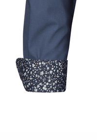 Polsino di camicia da uomo blu marina con un motivo floreale in bianco, blu e oro all'interno. Tessuto liscio, forma su misura.