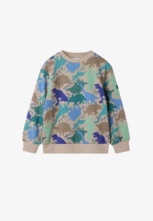 Beige crewneck trui met een meerkleurige dinosaurusprint in groen, blauw en bruin. Voorzien van geribbelde manchetten en zoom. Zachte textuur.