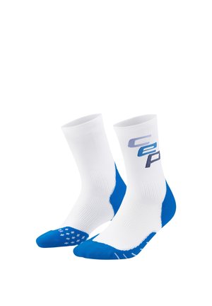 Pair of white athletic socks with blue heels, toes, and grip dots on soles, featuring blue and gray "Speed" text on the calf.