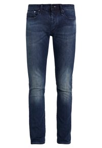 Mörkblå jeans med smal passform, lätt tvättad, femfickorsdesign och metallknappslutning med dragkedja. Tillverkade av denimtyg.