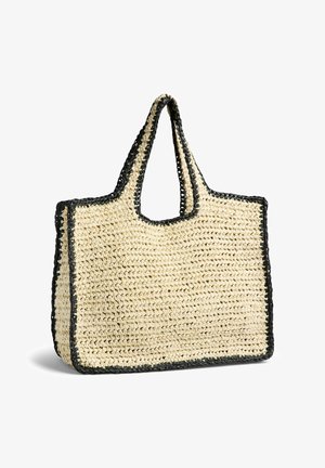 Sac cabas rectangulaire en paille tressée avec large bordure noire et poignées courtes, debout sur fond blanc.