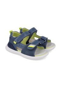 Sandalias de color azul marino con correas de Velcro, suela de goma y acentos en verde neón. Laterales perforados y plantilla acolchada para mayor comodidad.