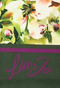 Floral fabric featuring green, pink, and white colors with a dark green band at the bottom displaying the "Liu Jo" logo in purple cursive.