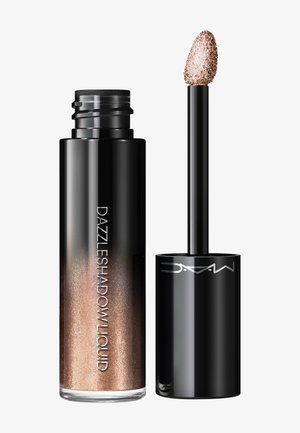Flüssiger Lidschatten in einem klaren Glasröhrchen mit einem spitzen Applikator. Der Farbton bietet eine schimmernde Bronze-Farbe und feinen Glitzer.