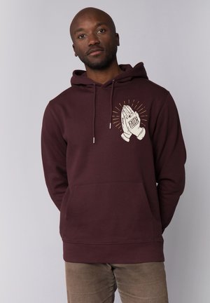 Maroon hoodie with a front pocket, featuring a printed graphic of clasped hands and the word "FAITH" in a contrasting color.