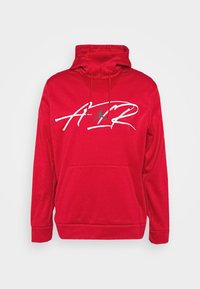 Sweatshirt à capuche rouge en tissu doux, avec une poche frontale et un texte graphique blanc avec un logo sur la poitrine.