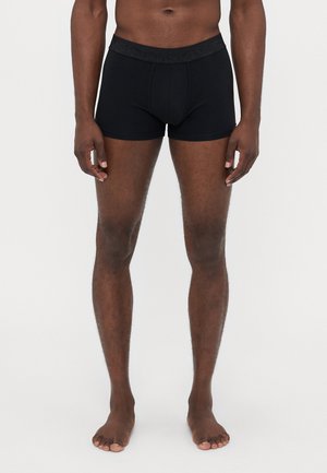 Sorte bomulds boxershorts med en tekstureret talje. Designet er tætsiddende og sømløst, med en blød og glat overflade.