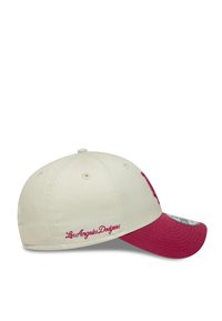 Baseball cap in off-white with a maroon bill. Features embroidered "Los Angeles Dodgers" and logo on the front. Made of durable fabric.