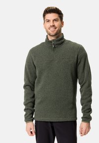 Pulover fleece verde cu fermoar, guler înalt, țesătură texturată și detaliu pe cusătura pieptului. Mâneci lungi, manșete ajustate și croială lejeră.