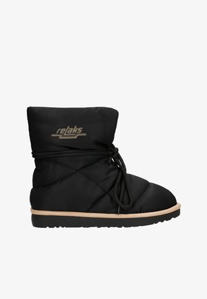 Zwarte gepolsterde enkelboot met een instapontwerp, voorzien van een gequiltte textuur, contrasterende lichtbruine zool en een strikdetail aan de voorkant.