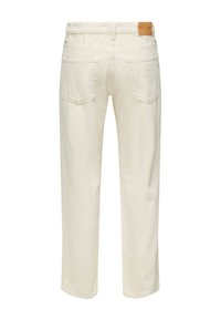White denim pants featuring a straight-leg design, two back pockets, and a leather brand label on the waistband.