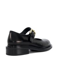 Black leather Mary Jane shoe with a block heel and double gold buckle strap, shown from the side on a white background.