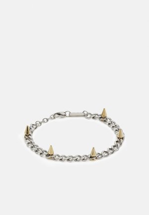 Bracelet chaîne en argent avec cinq pointes coniques dorées réparties uniformément et une fermeture à mousqueton sur fond blanc.