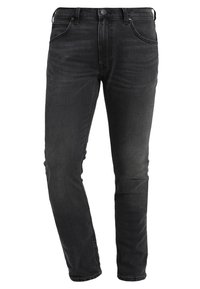 Jean noir slim avec poches avant et arrière, fermeture par boutons, et légère décoloration au niveau des cuisses et des genoux.