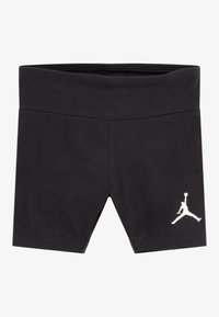 Čierne bavlnené šortky s vysokým pásom a priliehavým strihom. Na ľavej nohe sa nachádza biele logo Jumpman.