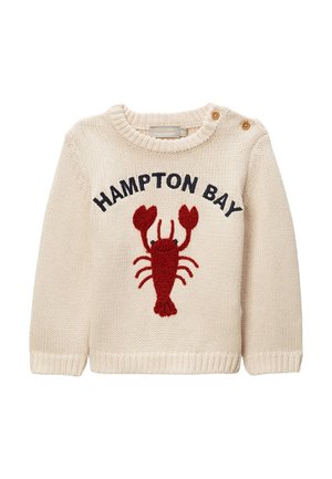 Pull bébé tricoté crème avec motif homard rouge, texte "HAMPTON BAY" et deux boutons marron près de l'encolure sur l'épaule gauche.