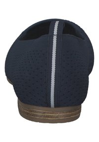 Navy blue slip-on shoes with a textured fabric upper, featuring a white striped accent and a brown, textured sole.