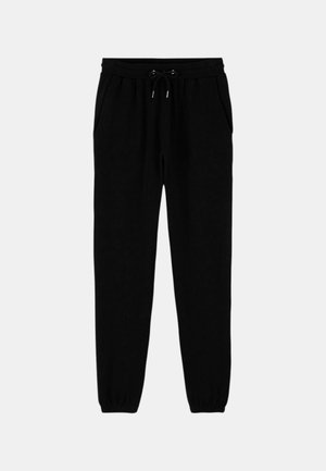 Pantalons de jogging noirs en tissu doux, avec une taille élastique dotée de cordons de serrage, des poches latérales et des poignets élastiques aux chevilles.