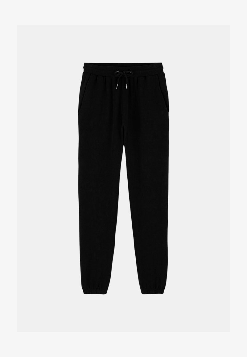 Pantalons de jogging noirs en tissu doux, avec une taille élastique dotée de cordons de serrage, des poches latérales et des poignets élastiques aux chevilles.
