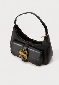Black leather handbag with short handle, gold zipper, and front flap featuring gold snake-shaped clasp engraved "Just Cavalli Milano."