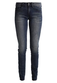 Mörkblå denimjeans med slim fit, med en mid-rise midja, femficksdesign och subtil blekning på låren.