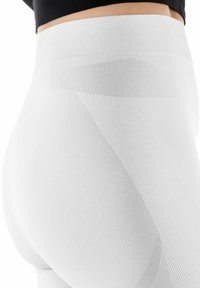 Witte hoge taille legging gemaakt van textuurstof met een gladde tailleband en diagonale ribbelpatronen, met een aansluitende pasvorm.