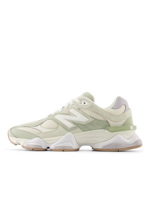 Light green and beige New Balance sneaker with mesh and suede panels, white chunky sole, and lace-up closure, side view on white background.
