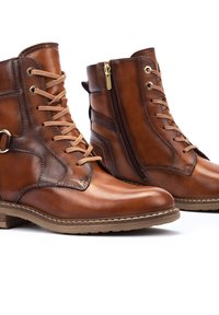 Brown leather ankle boots with lace and zip closure, rounded toe, decorative stitching, and a low stacked heel.