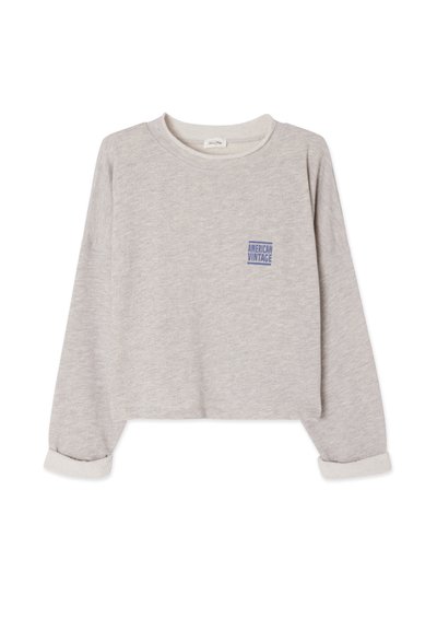 Sweat-shirt gris court en tissu doux. Il présente un col rond, des manches longues avec des poignets roulés, et un petit logo bleu à l'avant.