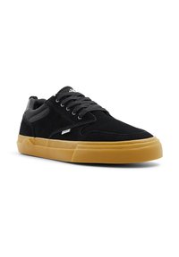 Black suede sneakers with a rubber gum sole, featuring a smooth texture, round laces, and mesh accents on the tongue and collar.