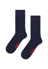 Chaussettes en coton bleu marine avec une bordure à côtes, un renfort au niveau des orteils et le texte rouge "HAPPY" sur le côté. Texture lisse, design de longueur crew.