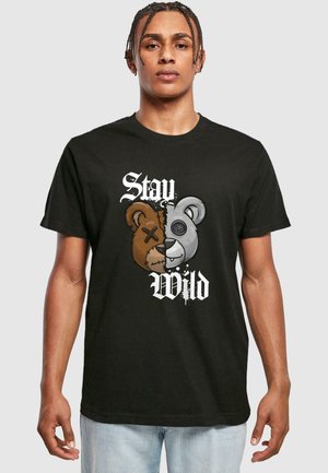 Black cotton t-shirt featuring a graphic of a two-tone bear head with stitched details, accompanied by the text "Stay Wild" in white.