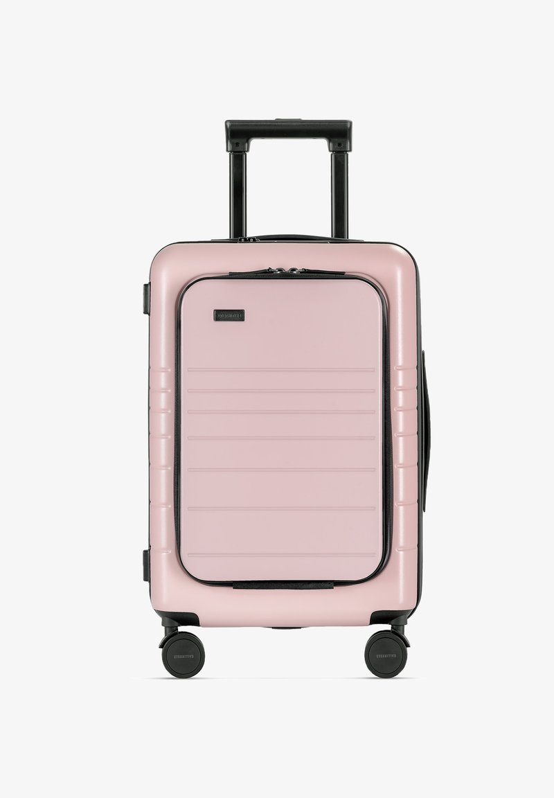 Hartschalen-Koffer in Pink mit strukturierten Oberflächen, schwarzen Akzenten, ausziehbarem Griff und vier Rädern für einfache Mobilität.