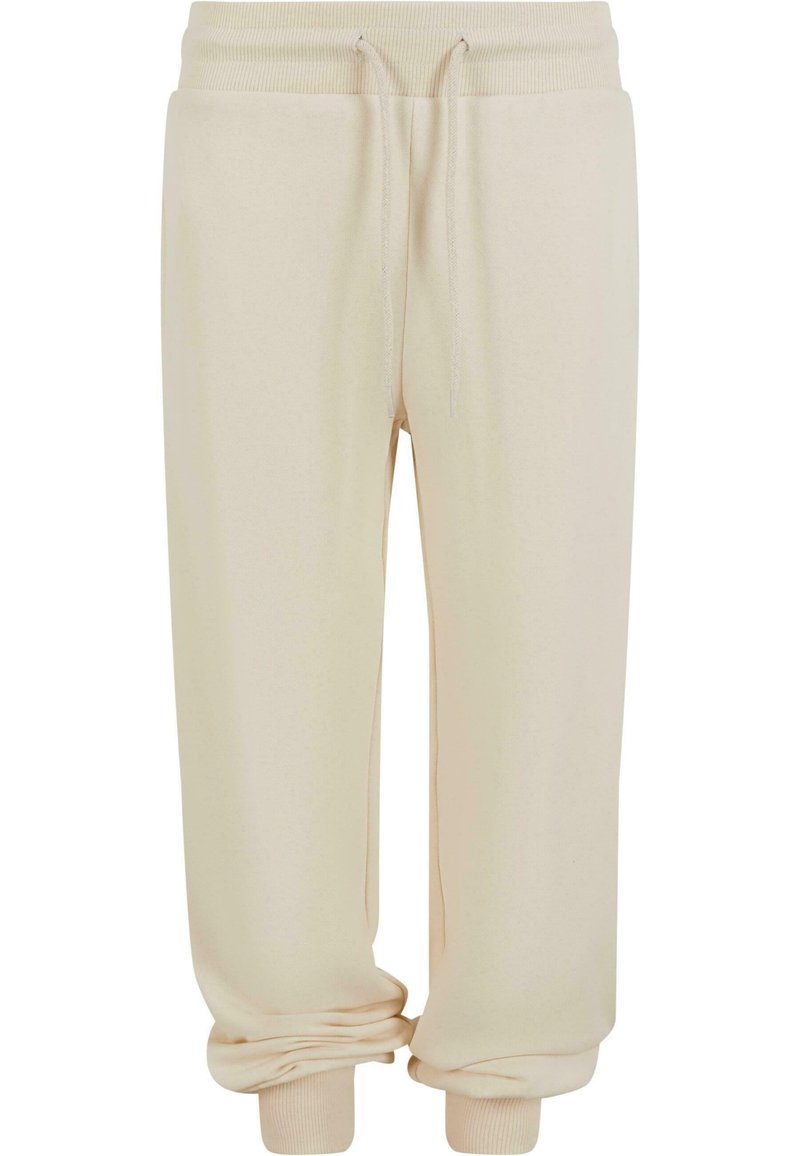 Pantalons de survêtement beige avec taille à cordon, poignets côtelés et texture douce. Le design présente une coupe décontractée pour un maximum de confort.