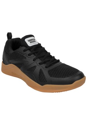 Black athletic shoe with a breathable mesh upper, rubber outsole, and a contrasting gum sole. Features flat laces and a padded collar.