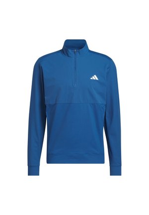 Plavi pulover s visokim ovratnikom, četvrtastim patentnim zatvaračem i dugim rukavima. Ima bijeli logo na lijevoj strani prsa i glatki, lagani materijal.