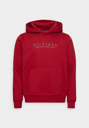 Red pullover hoodie with a front pocket, featuring a logo that reads "HILFIGER NEW YORK" in blue and white. Soft fabric, ribbed cuffs.