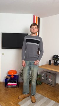 Gray knit sweater with black and light gray horizontal stripes, paired with light blue jeans and tan boots. Modern, casual design.