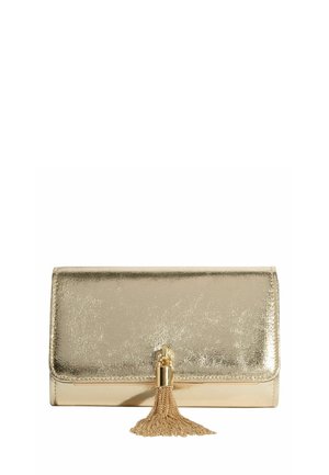 Kuldne metallikvärkidega kott läikiva tekstuuriga pinnaga ja dekoratiivse kett-tuduri esikaanel.
