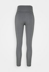 Leggings grises con una cinturilla alta, fabricados con tejido elástico. Presentan costuras planas para mayor comodidad y un acabado suave.