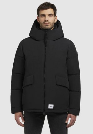 Black padded jacket with a hood, front zipper, and two large side pockets. Features a logo tag at the bottom. Smooth texture and streamlined design.