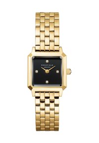Reloj metálico dorado con caja rectangular, esfera negra, cinco marcadores de hora con forma de diamante y pulsera de oro texturizada.
