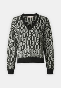 Maglione a V in nero e grigio chiaro con motivo geometrico, lavorazione a maglia texturizzata e dettagli in strass lungo l'orlo e la parte frontale.