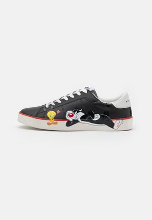 Czarny sneaker z białymi sznurówkami z Tweety i Sylwestrem z Looney Tunes, gdzie Tweety stoi, a Sylwester leży na boku.