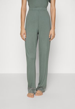 Lichtgroene, loszittende broek met een elastische tailleband en verfijnde kantdetails aan de onderranden. Zachte, gladde stoftextuur.