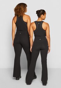 Athleta ELATION FLARE PANT - Leggings - black