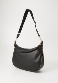 Black leather handbag with a rounded shape, textured surface, gold hardware accents, and a detachable shoulder strap. Zipper closure details.